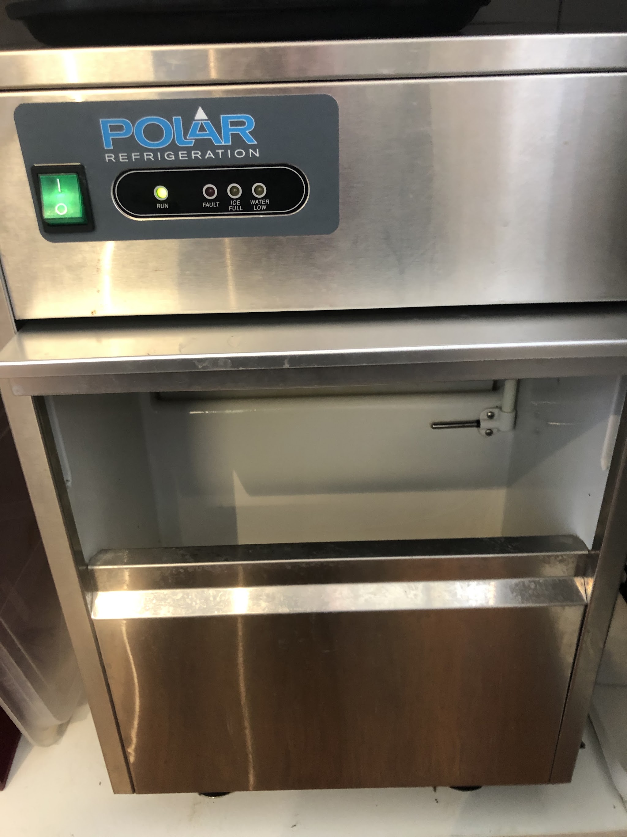 A Polar Refrigeration stainless steel commercial ice machine with its run light lit after service by MixAir
